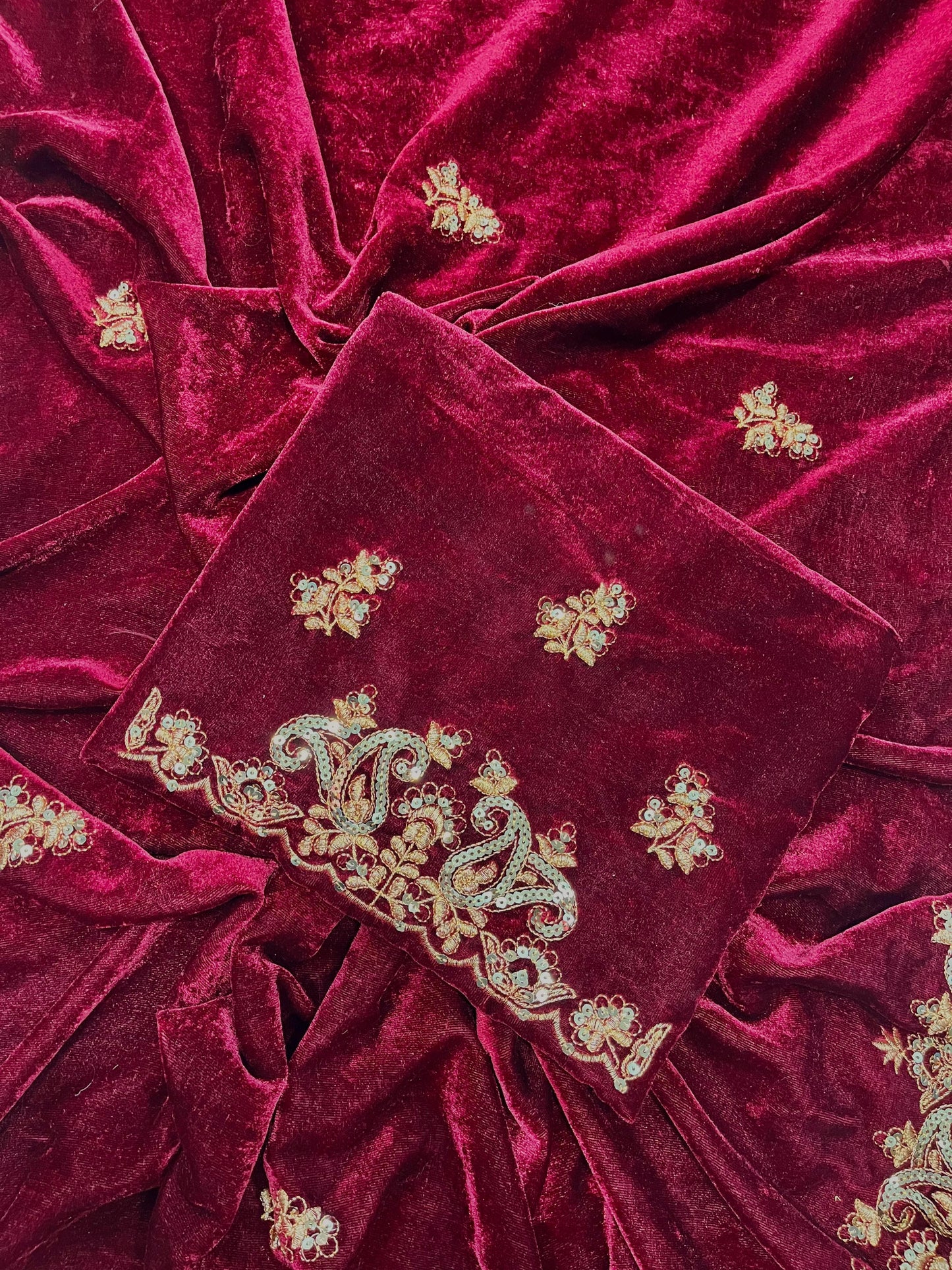"Radiant Elegance: This deep maroon velvet saree, embellished with exquisite golden embroidery, exudes regality and charm, perfect for grand celebrations."
