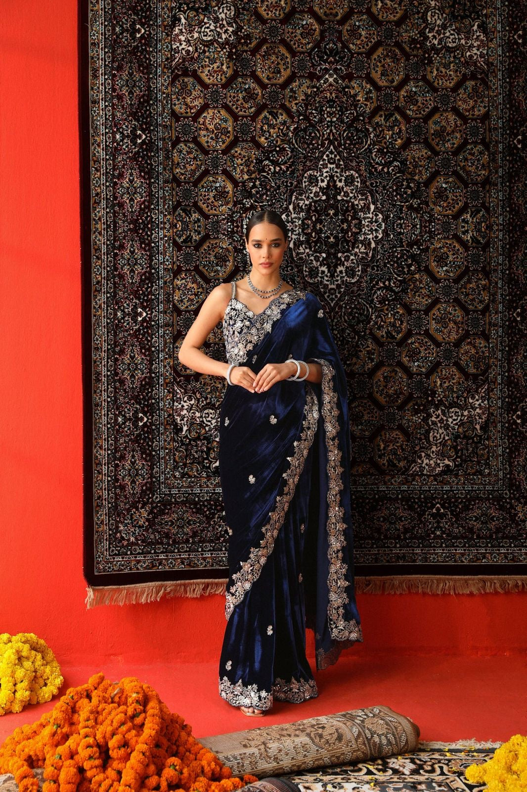 "Elegance Redefined: This royal blue velvet saree adorned with intricate silver embroidery is the epitome of timeless grace and sophistication."
