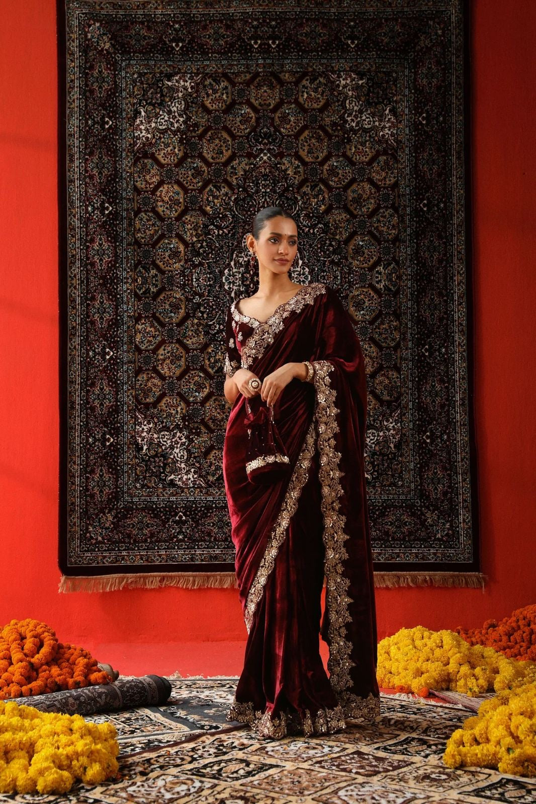 "Radiant Elegance: This deep maroon velvet saree, embellished with exquisite golden embroidery, exudes regality and charm, perfect for grand celebrations."