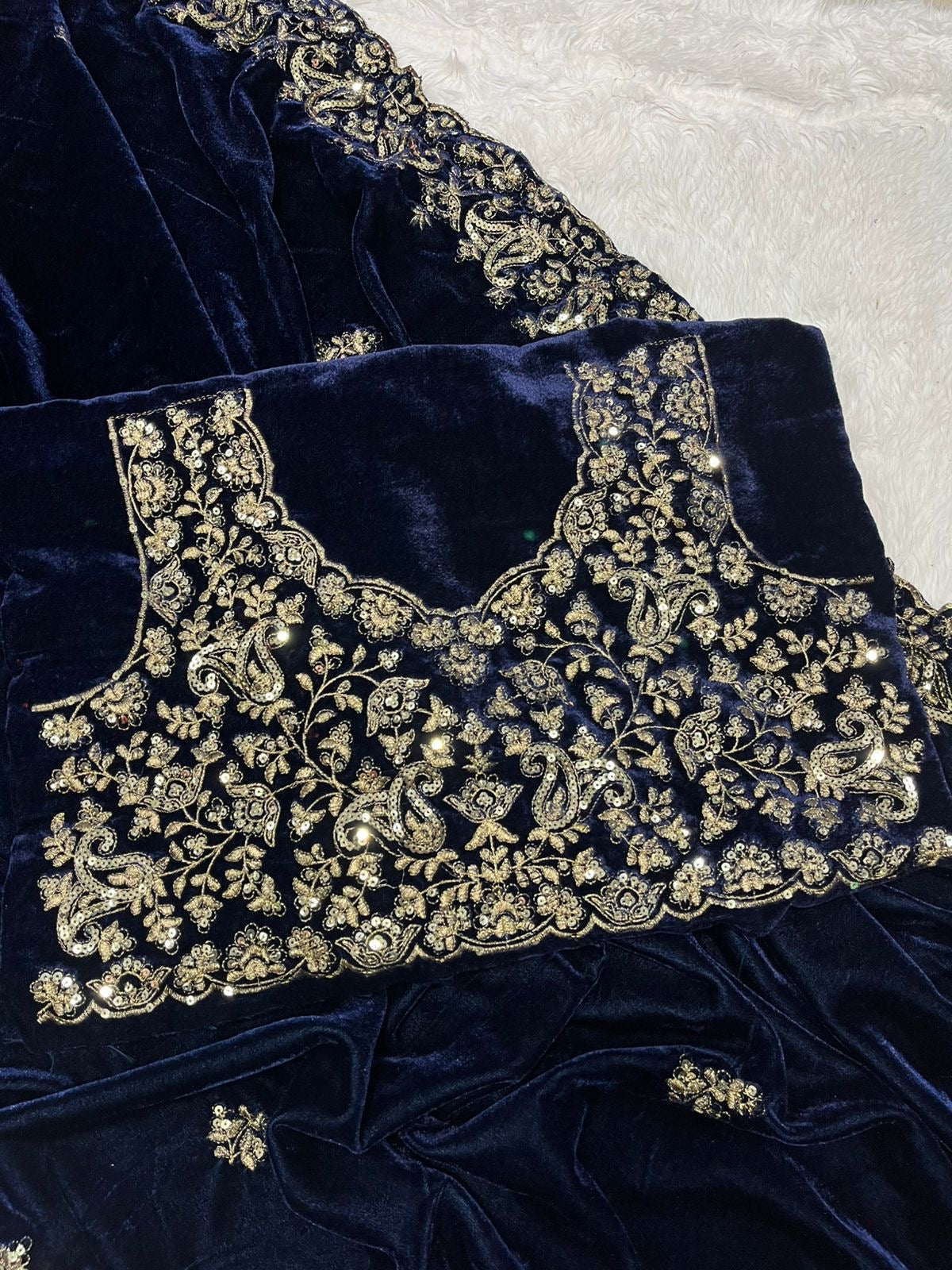 "Elegance Redefined: This royal blue velvet saree adorned with intricate silver embroidery is the epitome of timeless grace and sophistication."
