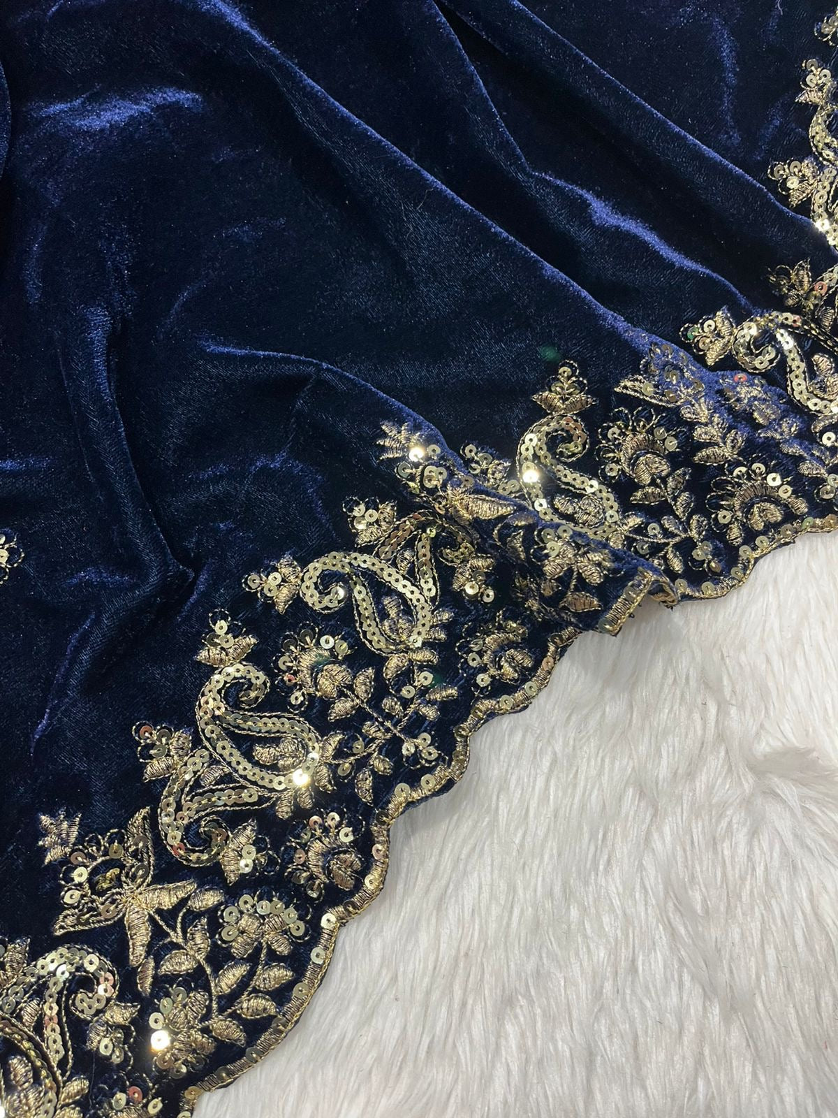 "Elegance Redefined: This royal blue velvet saree adorned with intricate silver embroidery is the epitome of timeless grace and sophistication."