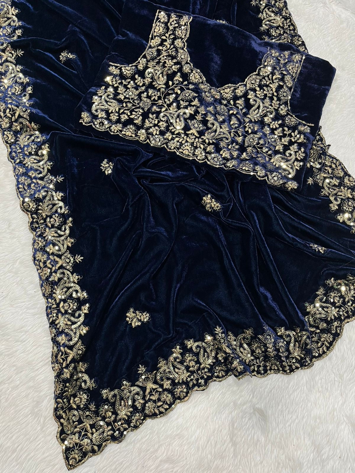 "Elegance Redefined: This royal blue velvet saree adorned with intricate silver embroidery is the epitome of timeless grace and sophistication."